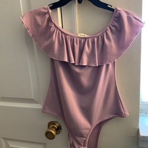 Lilac body suit with off shoulder sleeves.